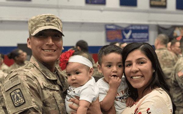 Picture of military member, their spouse and children. Picture of military member, their spouse and children.